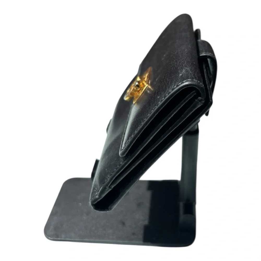 Authentic Ferragamo black leather trifold wallet gold with callouts